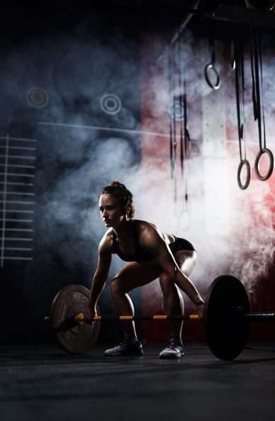 Powerful female weightlifting in sports club